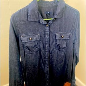 Gap denim shirt with dark pearl buttons. This woman’s shirt is dark denim.